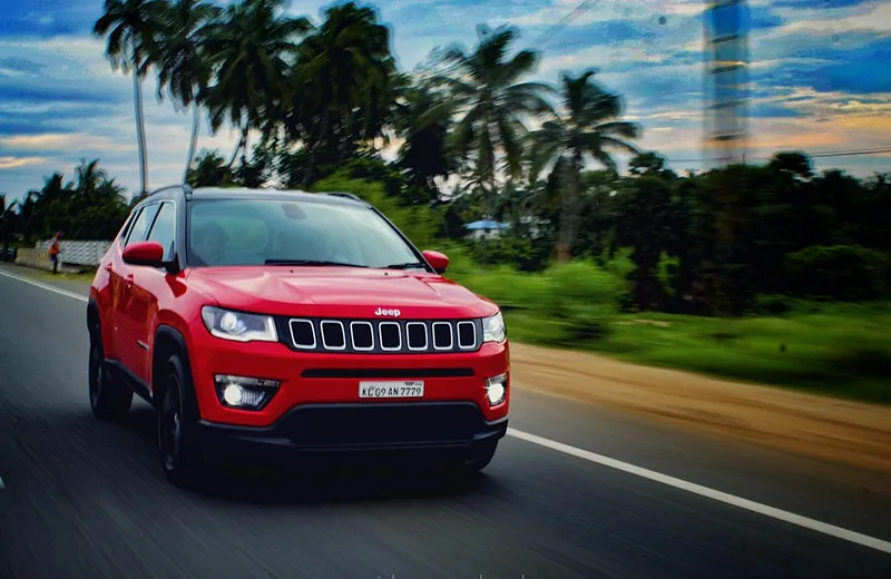 A rental SUV on a coconut-palm-lined Kerala road on the way to Varkala