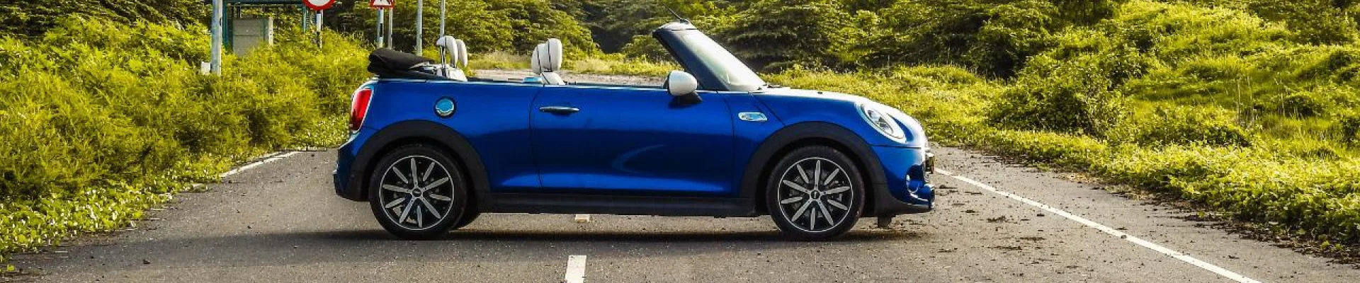 Blue convertible rental car on an open road in Trivandrum, Kerala