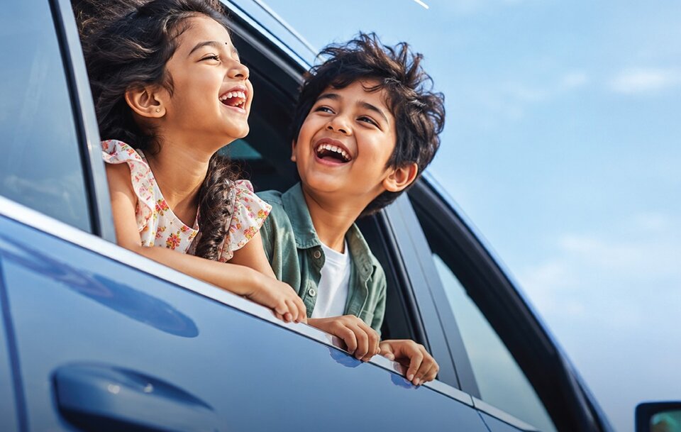 Vacation car rental offer - happy children enjoying a family road trip with Apple Car Rentals
